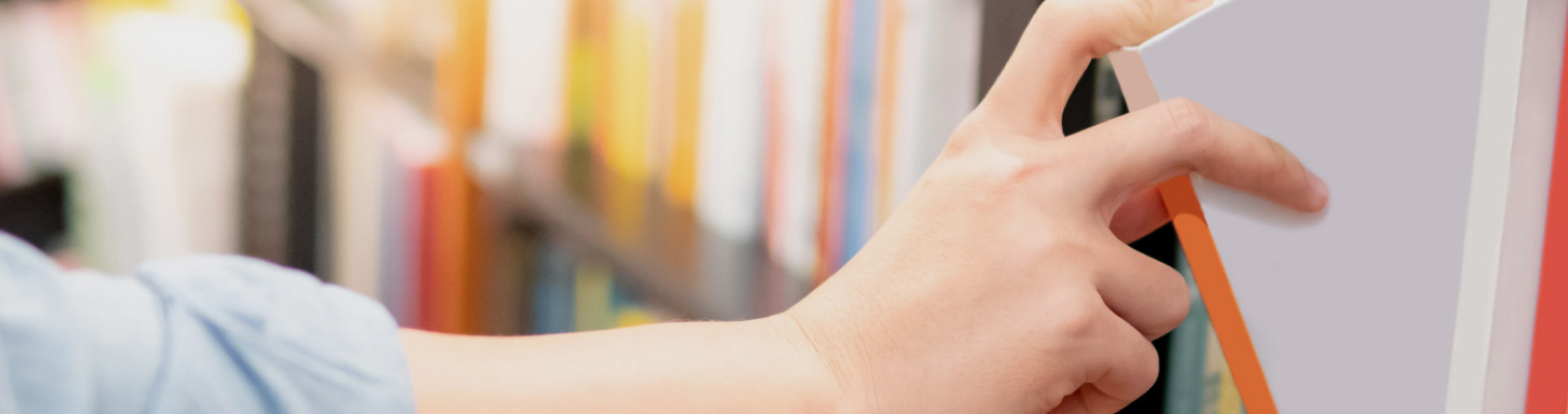 Hand taking records or book soff shelves.