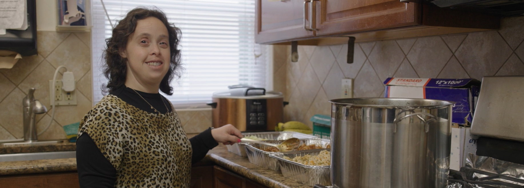 Woman with developmental disability working in kitchen