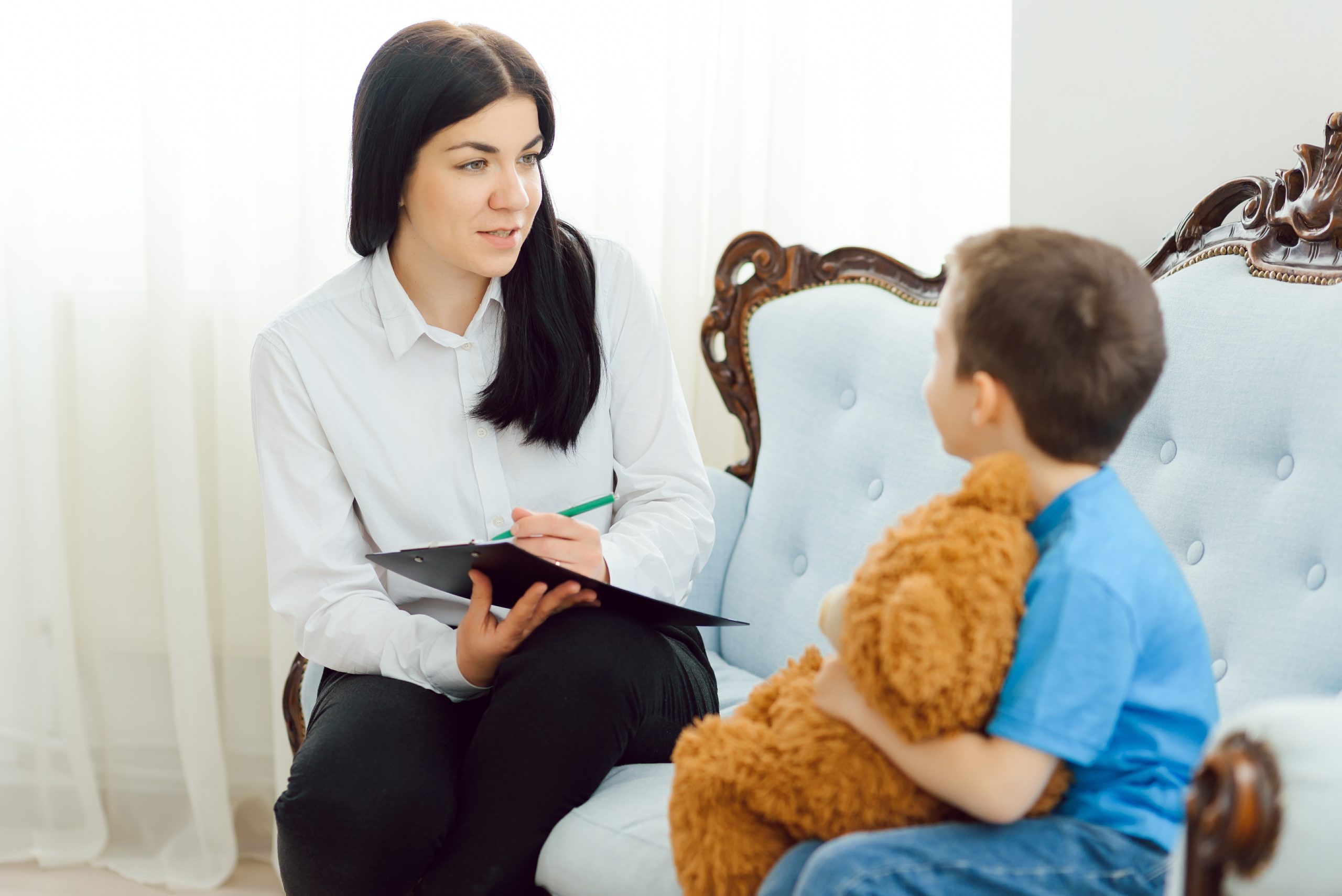 Child psychologist attending small boy.