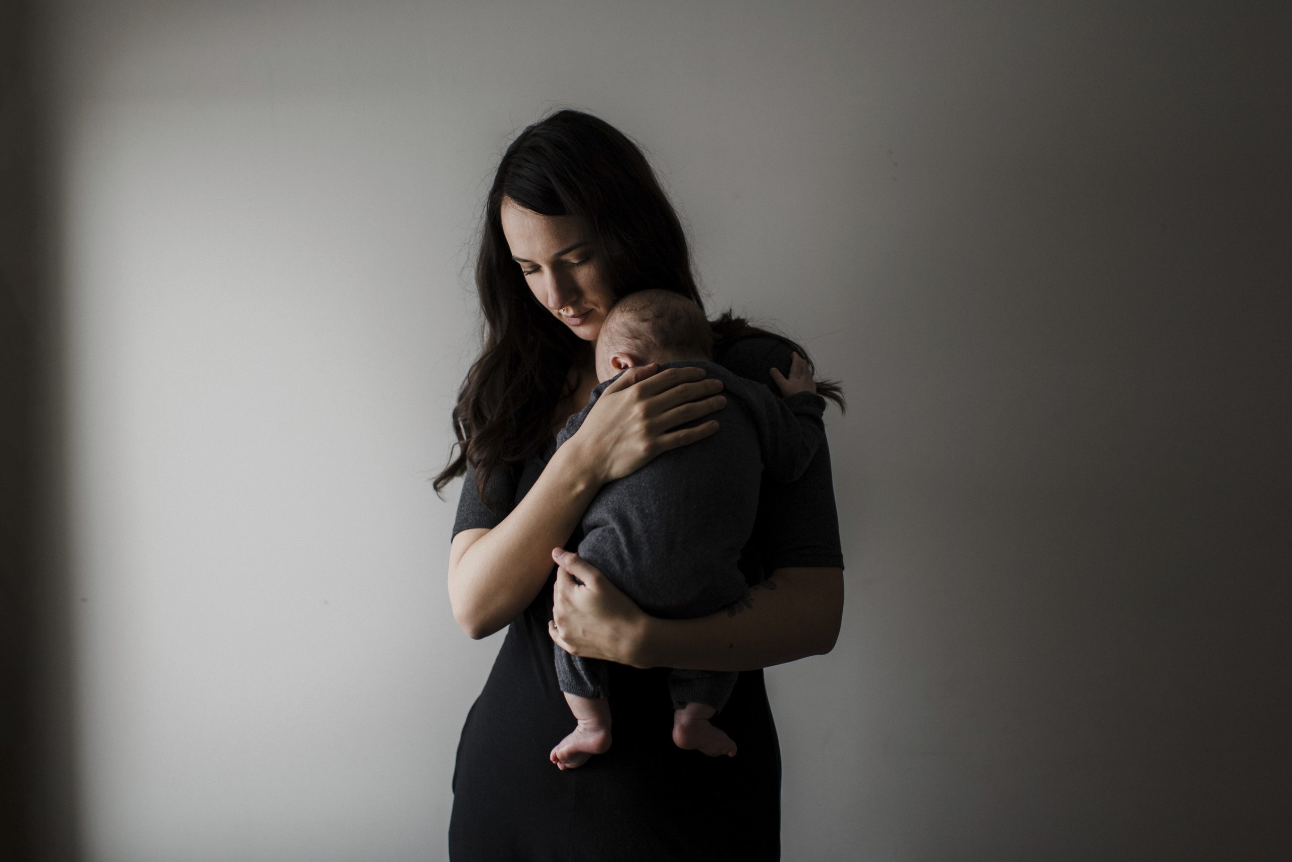 Mother cradles her sleeping baby.
