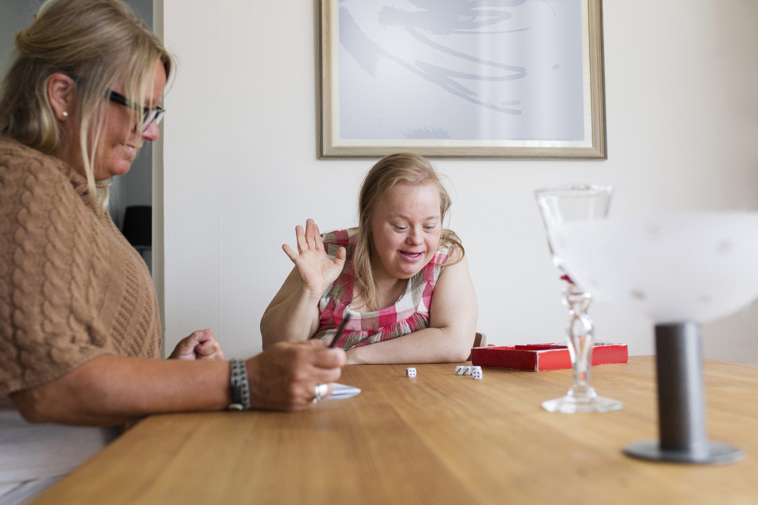 Woman and child with down syndrome playing game