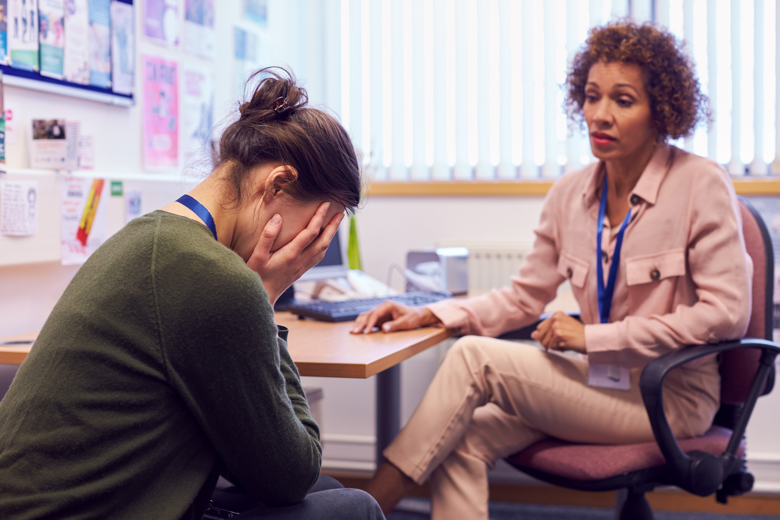 Young woman sitting receiving counseling from a therapist.