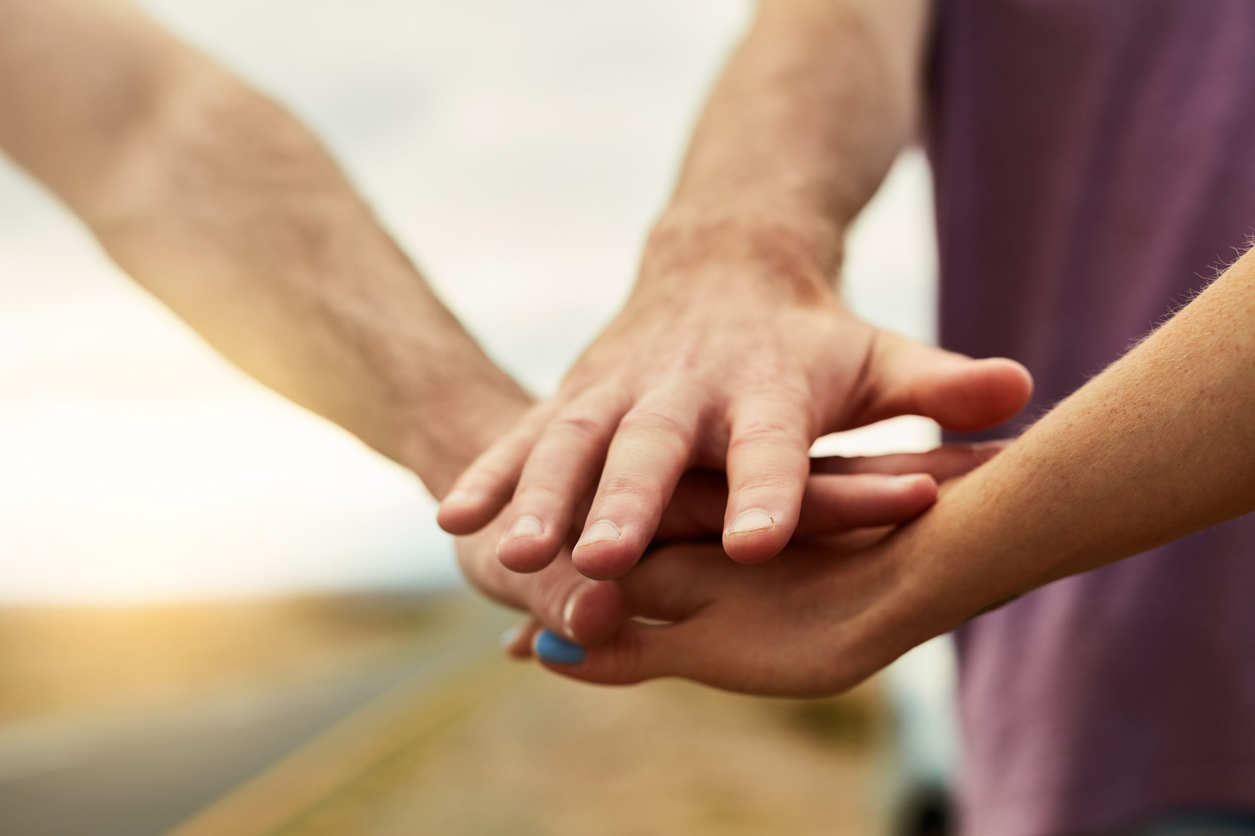 Hands stacked in show of support for each other.