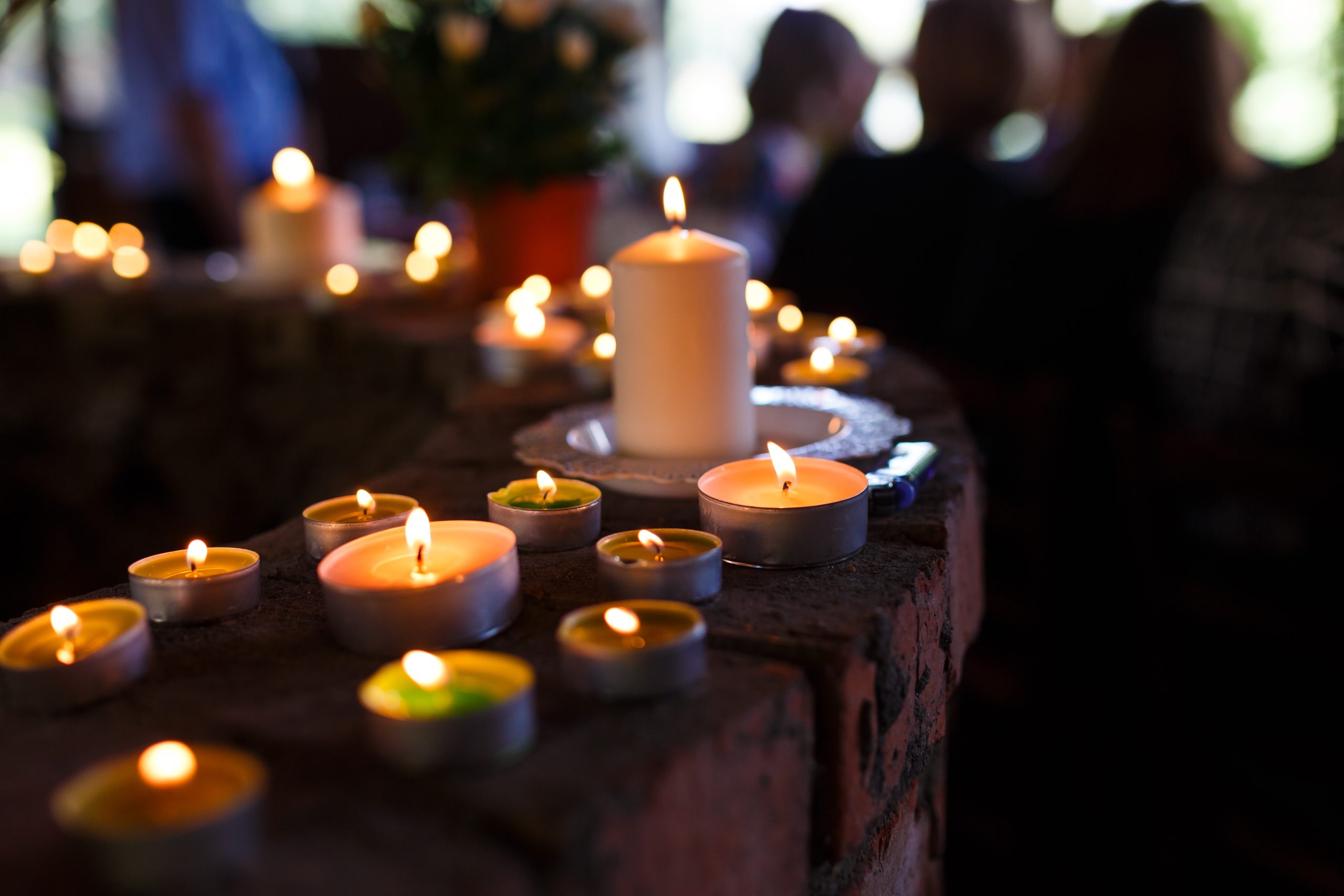  Candles lit in a row illustrating a memorium.
