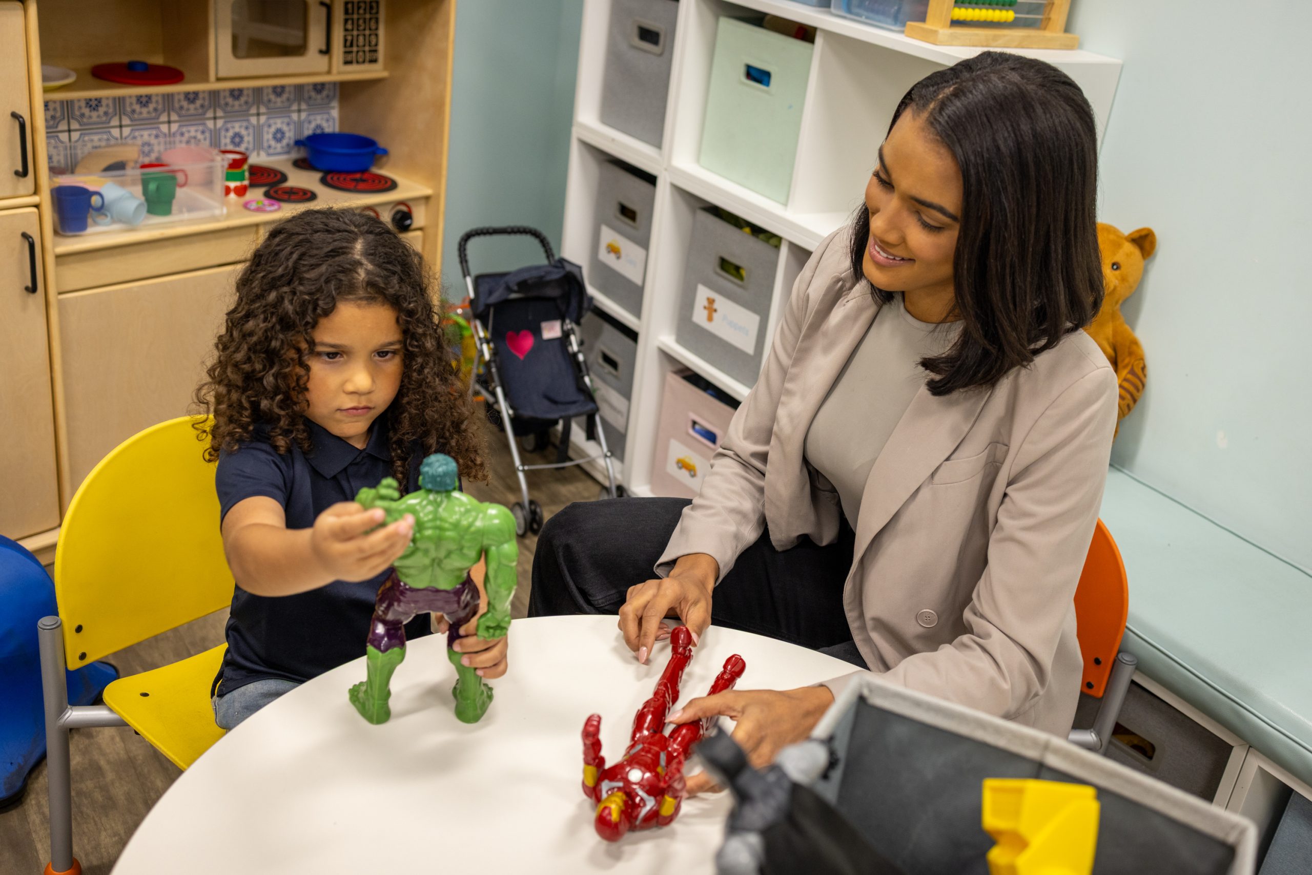 Therapist treats child using play therapy.